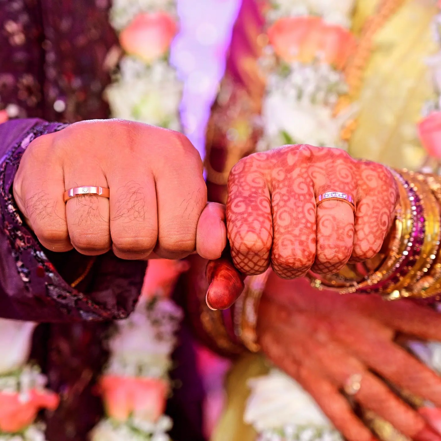 Vijayalakshmi and Pradeep Reddy’s hands joined ring to ring, henna and bangles in focus